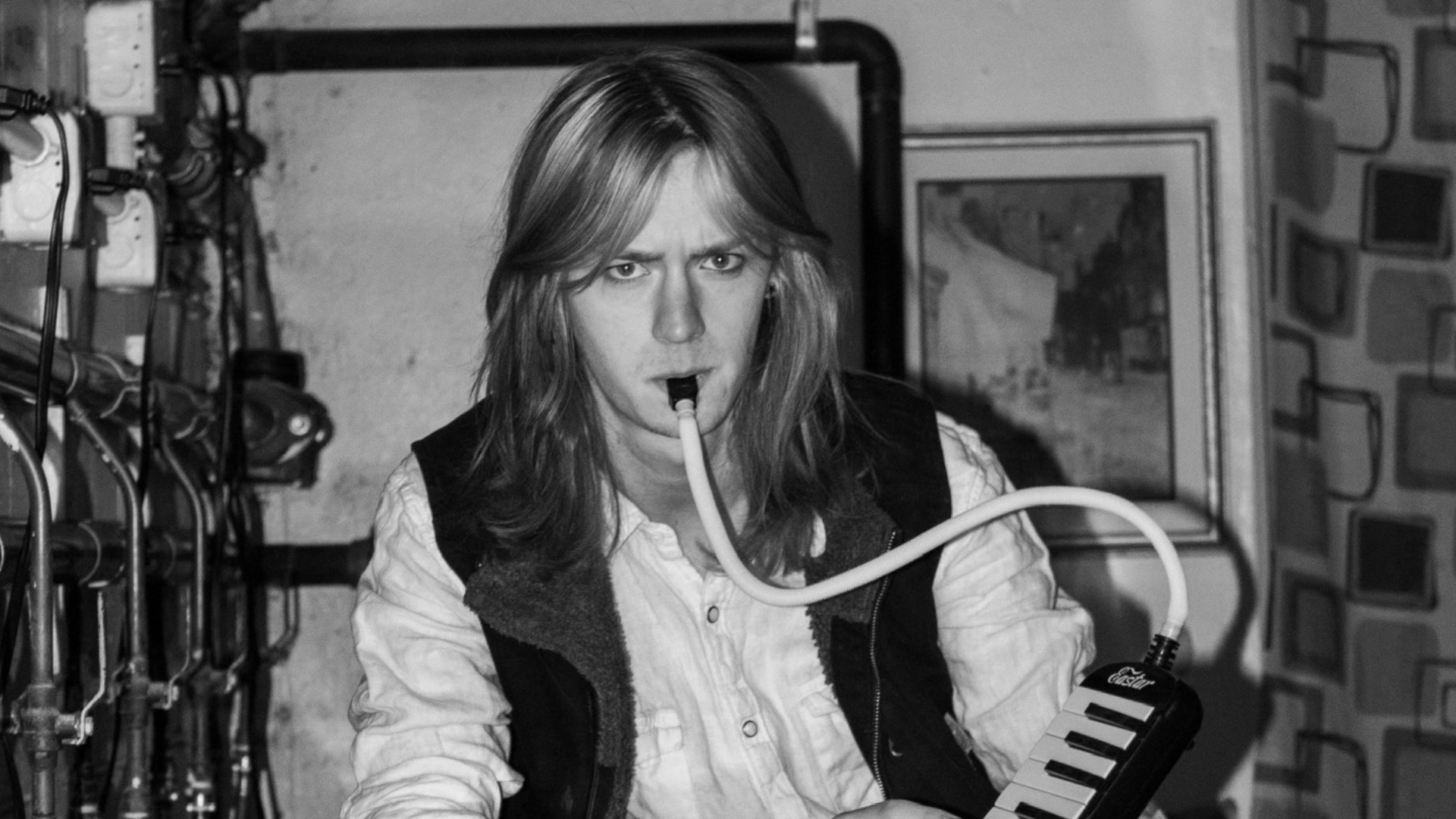 Bobby Nair is screaming next to a disco ball.